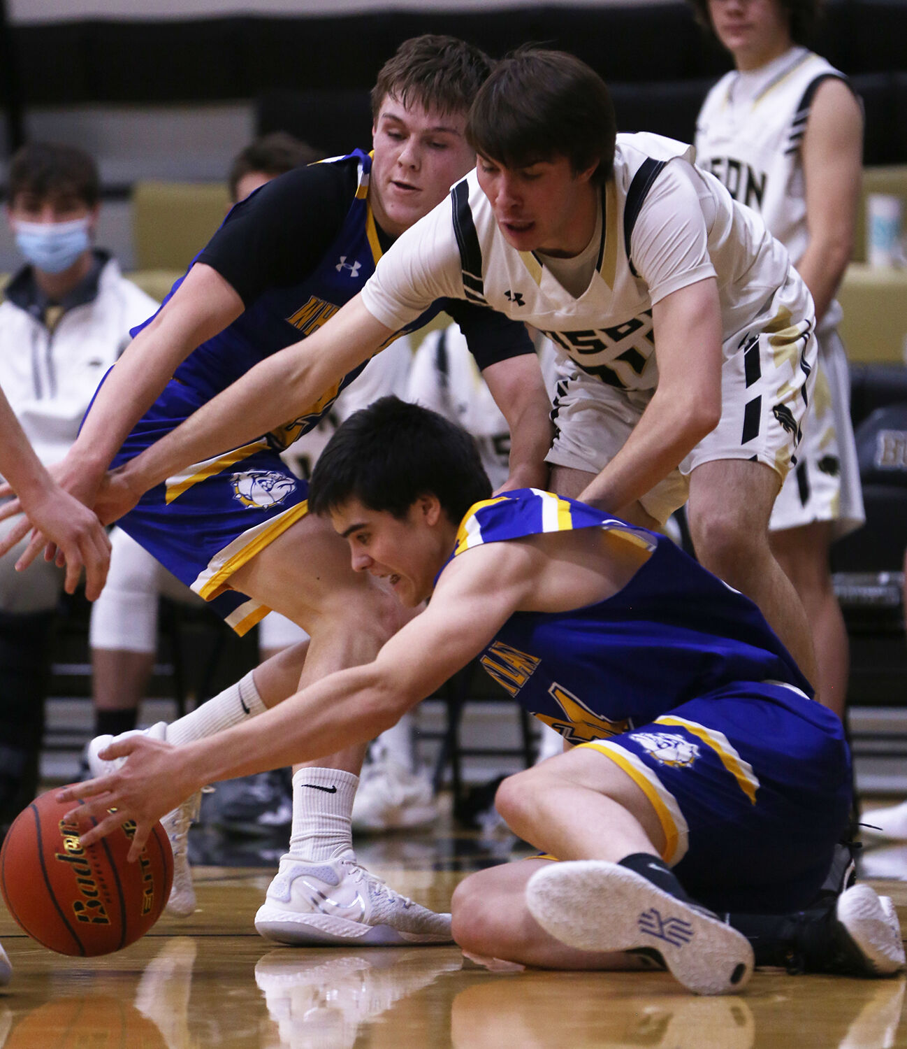 Colby Bessler stretches over the top of Wheatland junior Khai Johnson